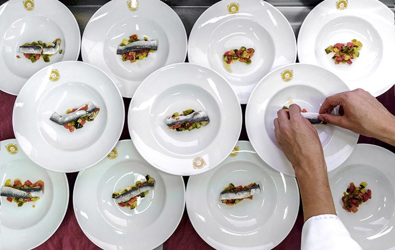 Small portions of fish and vegetables are plated on a luxury train travelling around Andalusia.