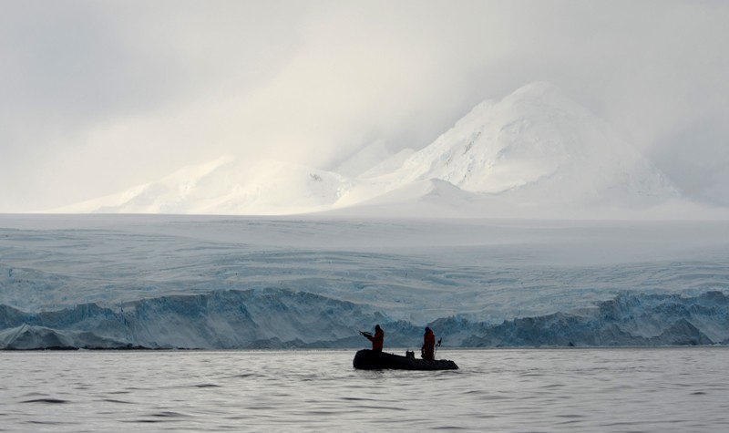 Researchers in a small boat in the Antarctic