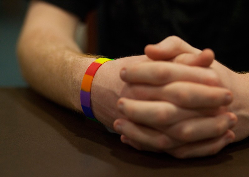 Man wearing a rainbow bracelet