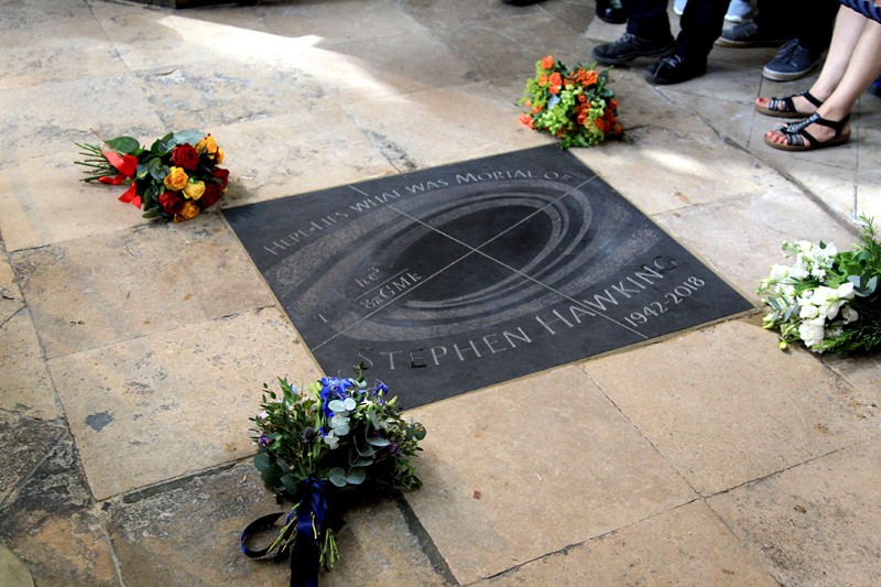 A memorial stone with the text 'Here lies what was mortal of Stephen Hawking' can be seen during his memorial at Westminster.