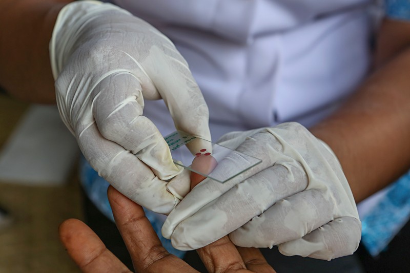 A blood sample is taken at an Indonesian malaria clinic