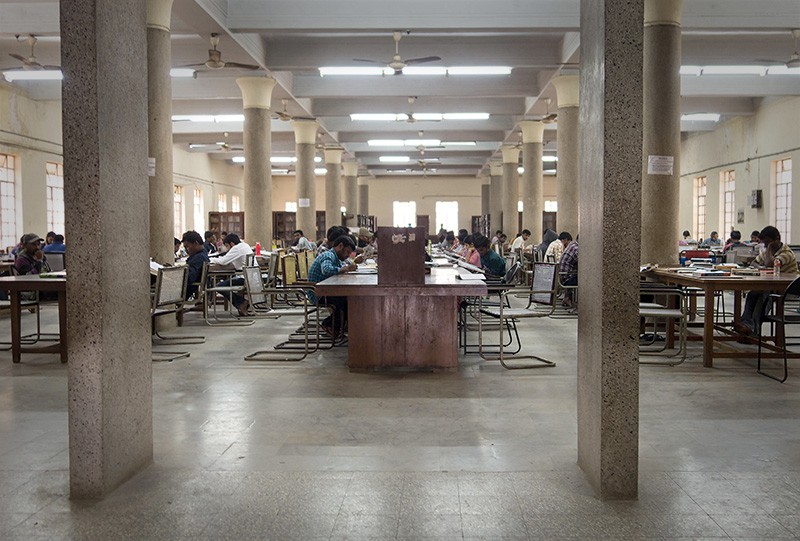 Students reading in rows at the reading room at Osmania University in Hyderabad, India in 2017.