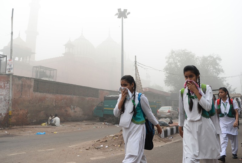 Schoolchildren cover their faces amid heavy smog in New Delhi