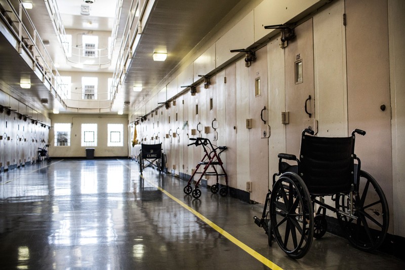 Wheel chairs and walkers sit outside prison cells