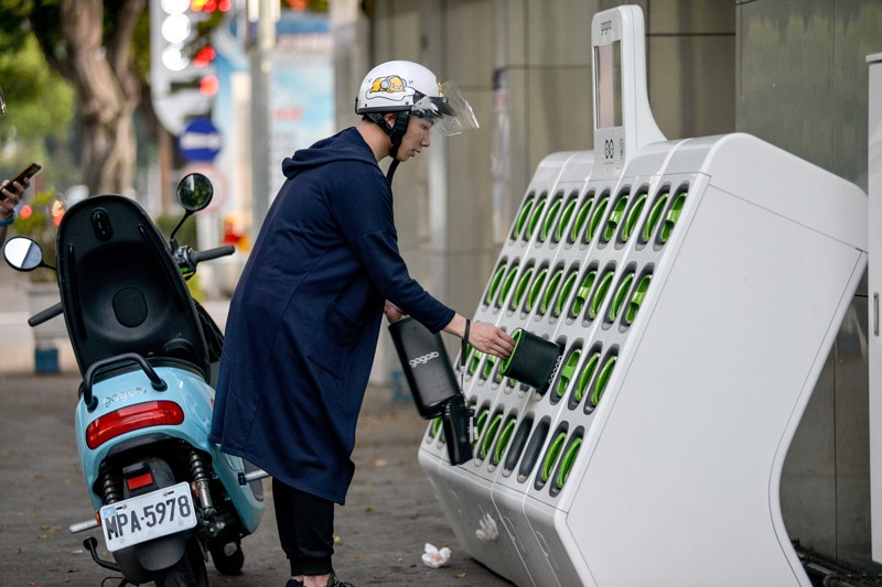 A motorcyclist uses a battery swapping station in Taiwan