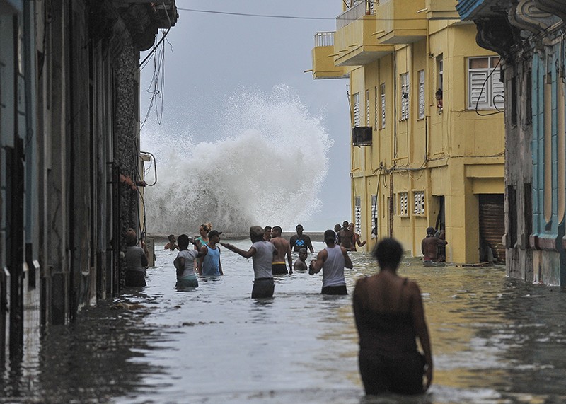 Cubans wade through a flooded street in Havana after Hurricane Irma in 2017.