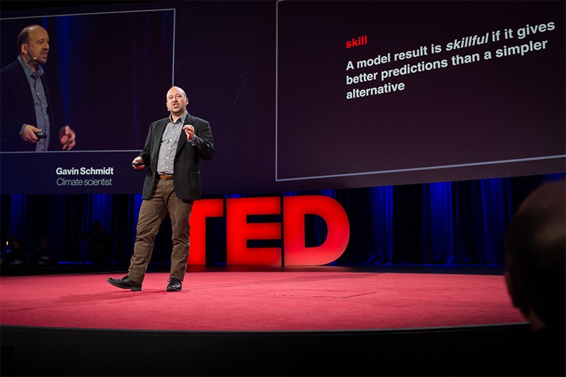 Gavin Schmidt paces in front of screens during a TED presentation in Canada in 2014