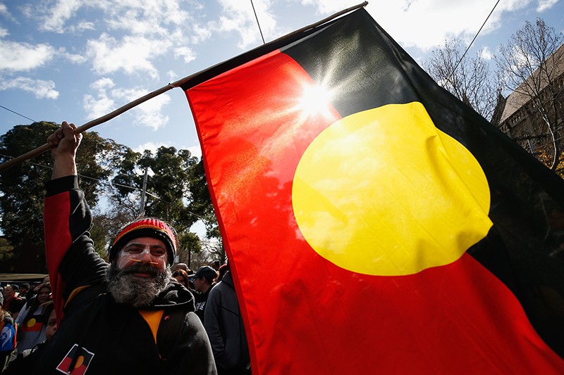 A flag is waved in celebration to celebrate the history, culture and achievements of Aboriginal peoples in Australia.