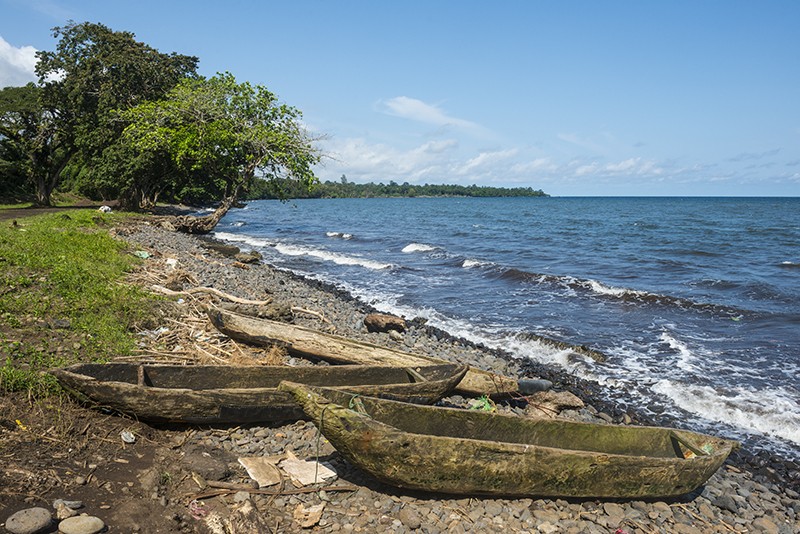 Wooden canoes on the rocky coast of the island of Bioko, Equatorial Guinea, Africa