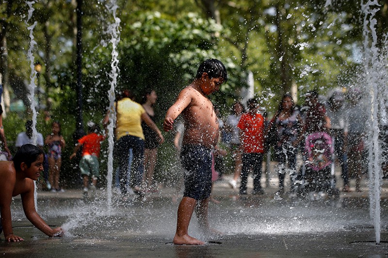 Children play in a fountain in Battery Park, New York City