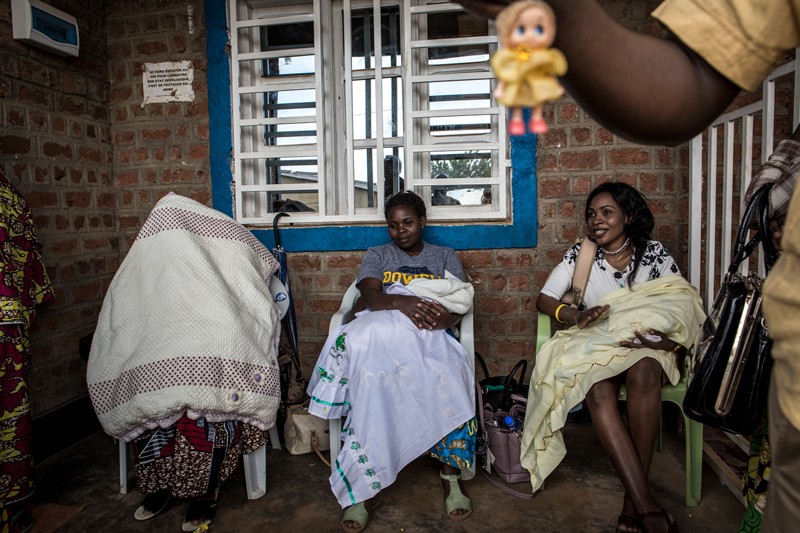 Three mothers recently cured of Ebola waiting for a medical check at an treatment centre, Beni, Democratic Republic of the Congo