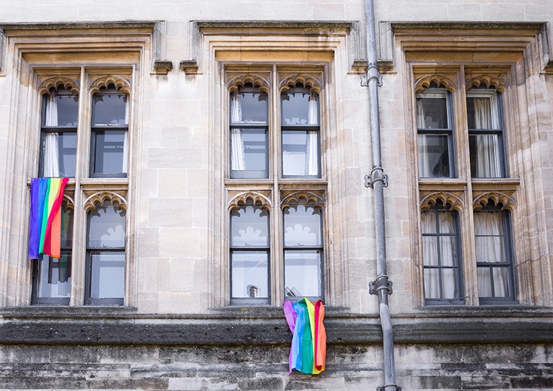 The exterior of Christ Church College, University of Oxford with rainbow flags