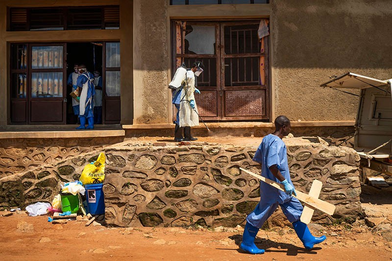 A morgue employee walks in front of the morgue entrance in Beni, Congo DRC.