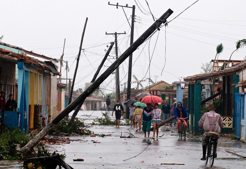 Locals walk in a damaged street after Hurricane Gustav in Pinar del Rio province,100 km west of Havana