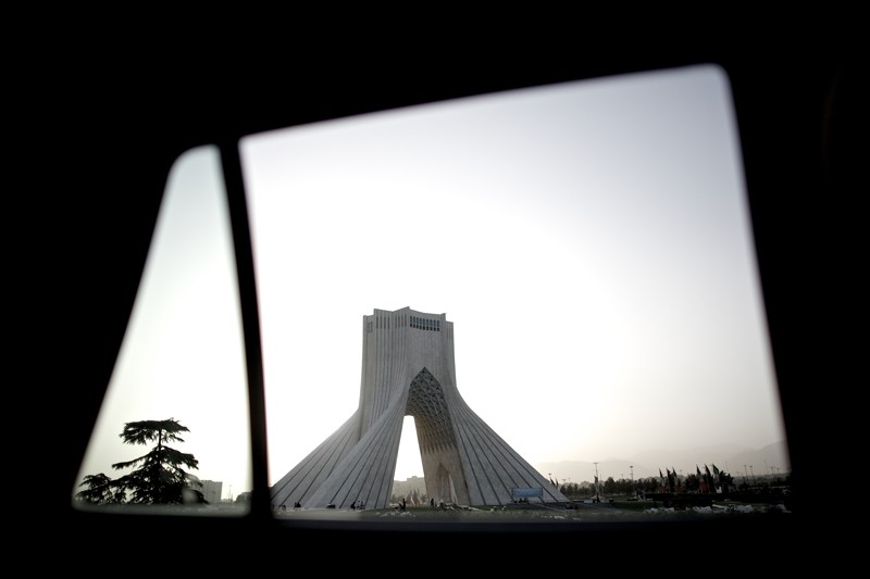 A picture taken from inside a car shows the Azadi tower at the western entrance of the Iranian capital, Tehran.
