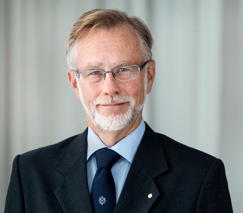 Göran Hansson, in a dark jacket and tie, photographed from the shoulders up.