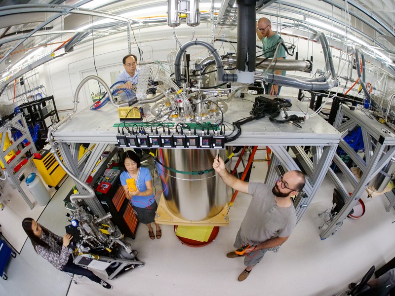 Memner of the Google quantum team work on a cryostat