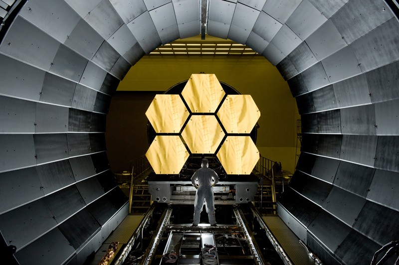 NASA engineer Ernie Wright looks on as the first six flight ready James Webb Space Telescope's primary mirror segments