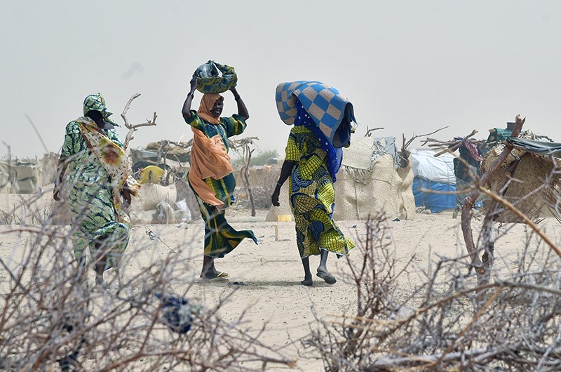 Women arrive in a camp in the village of Kidjendi near Diffa, Niger