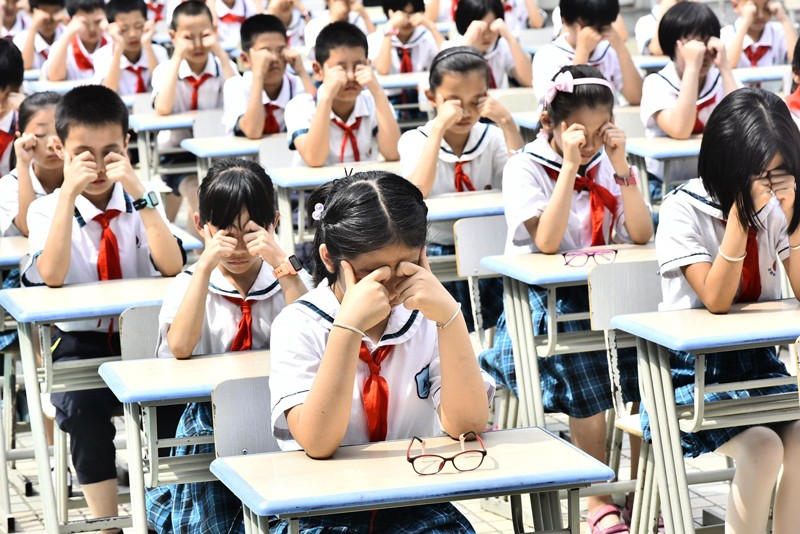 Students do eye exercises at Huangshanlu Primary School in Hefei, east China's Anhui Province