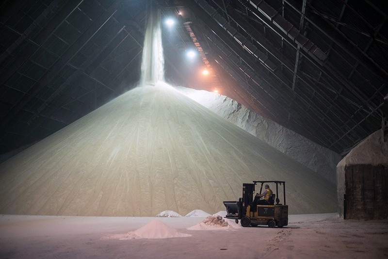 Raw sugar is offloaded from a cargo ship into a refinery and storage facility in Toronto, Ontario, Canada.