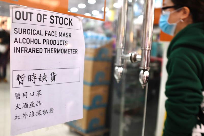A sign on the door of a pharmacy lists face masks, alcohol products and infrared thermometers as out of stock