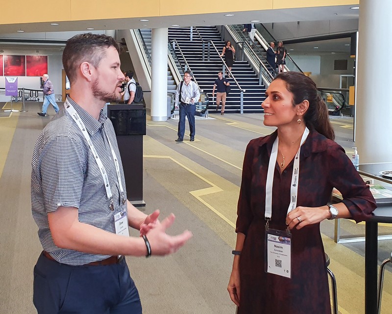 Drew Evans chatting to early career researcher Nasim Amiralian