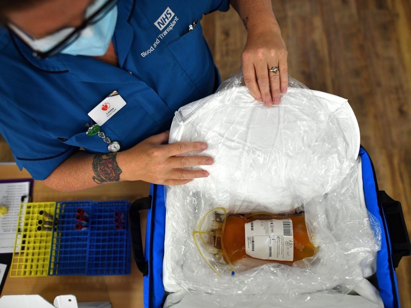 Blood plasma is prepared for delivery at a newly opened plasma donor centre in Twickenham, southwest London on June 11, 2020.