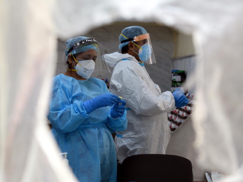 Health workers work with collected samples for coronavirus testing, New Delhi, India.