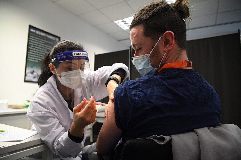 A care worker receives the Oxford-AstraZeneca Covid-19 vaccine