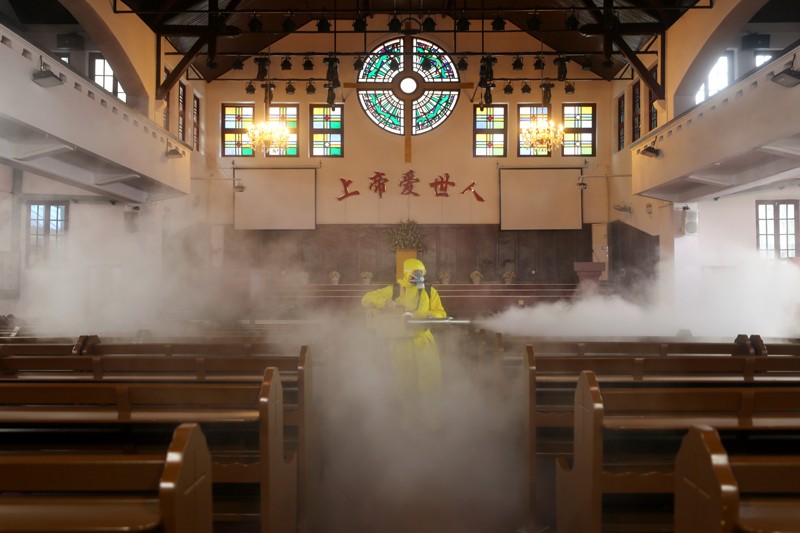 A volunteer disinfects a Christian church in Wuhan