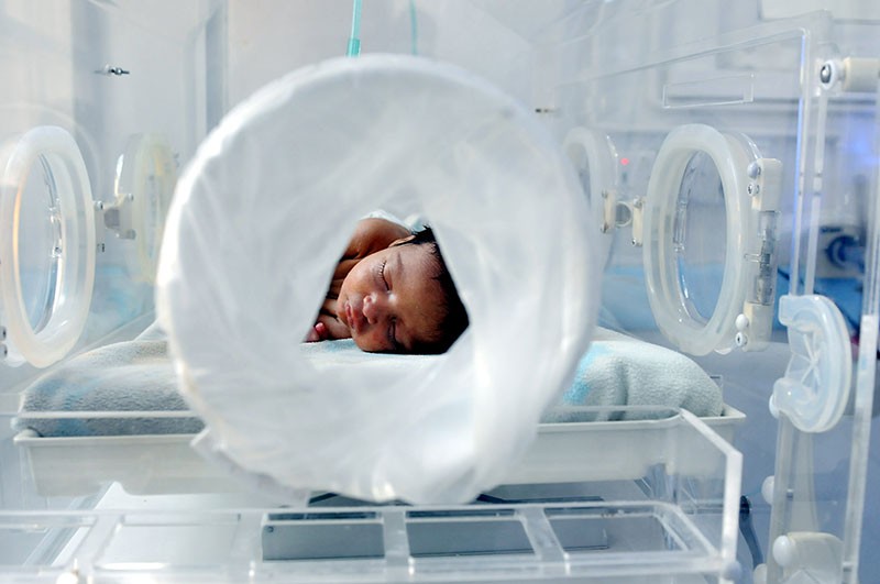 A premature baby lies in an incubator in the child care unit of a hospital in Yemen.