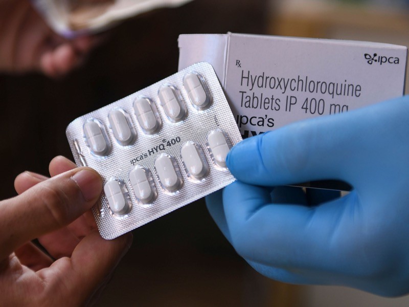 A vendor displaying hydroxychloroquine (HCQ) tablets at a pharmacy in Amritsar, India.