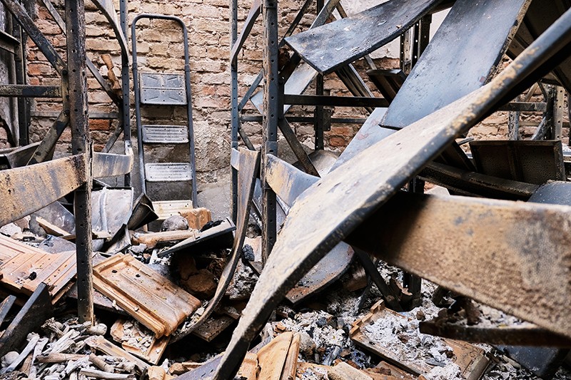 Rubble and the remains of fire-damaged storage racks.