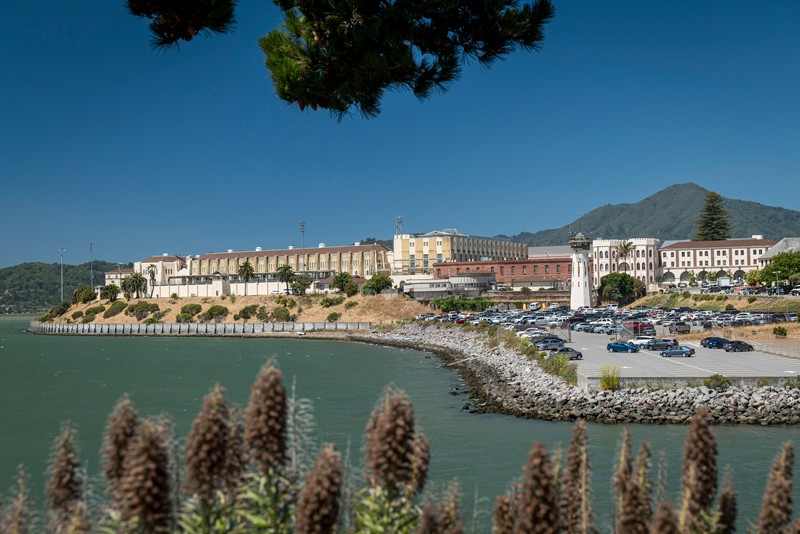 A prison on a promontory, seen from across the water.