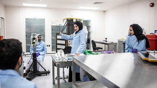 Muna al Hammadi and fellow engineers working in a lab at The Mohammed Bin Rashid Space Centre