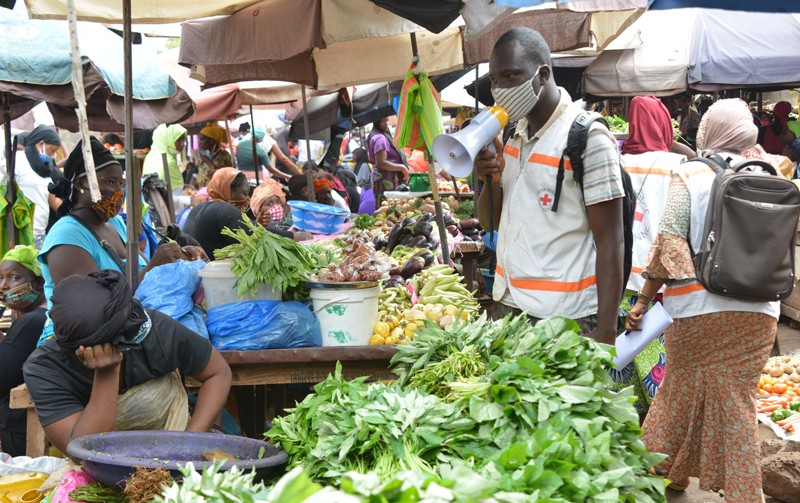 Members of the Guinean Red Cross inform people about the COVID-19 coronavirus in Conakry