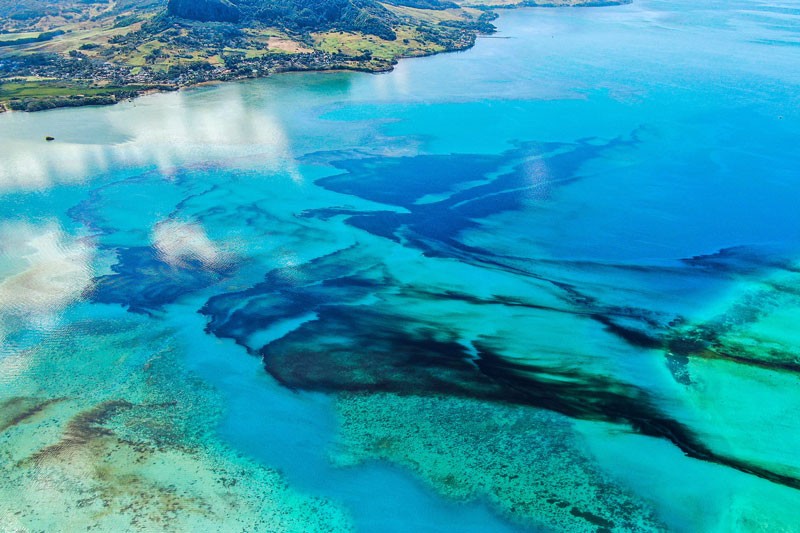 An aerial photograph shows oil drifting ashore from the bulk carrier ship that ran aground, Mauritius.