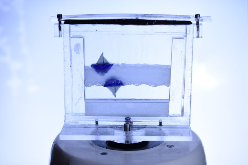 Small boats floating above and below over and under a levitated liquid layer