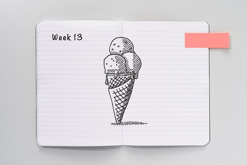 An open notebook with a sketch of an ice cream cone