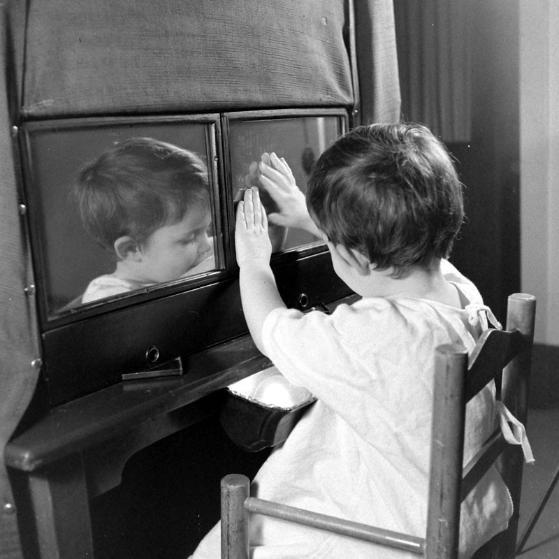 Child sitting on a chair during Columbia University normal child development study