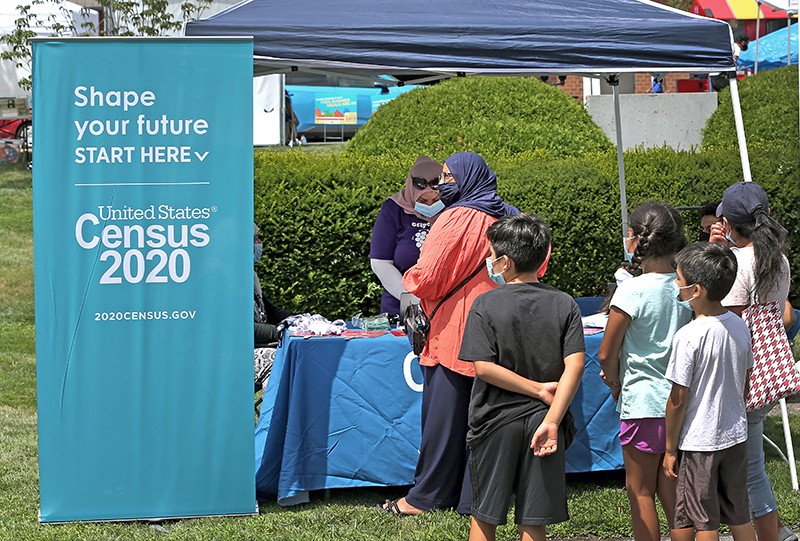 People stand in line at a Census 2020 booth in Everett, Massachusetts, USA