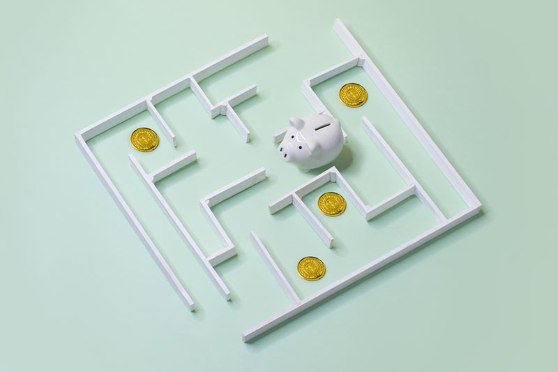 Piggy bank in a maze with coins