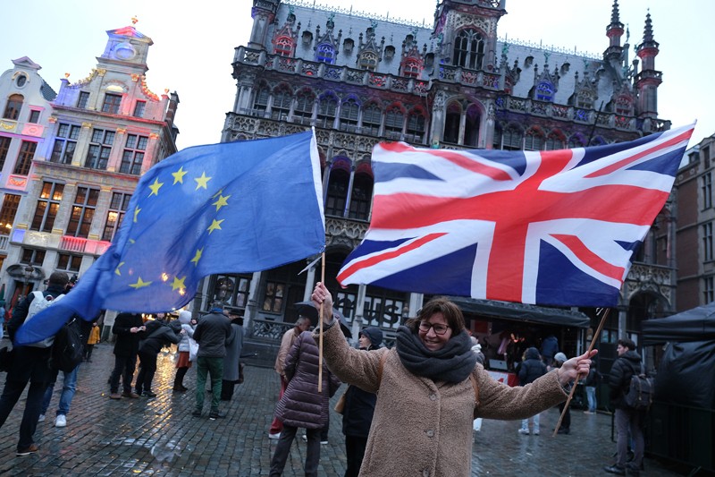 A British citizen living in Brussels waving EU and British flags