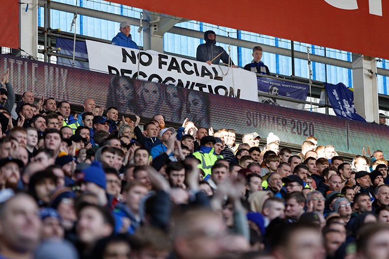 A No Facial Recognition banner with fans in seats at a football match in Cardiff, Wales