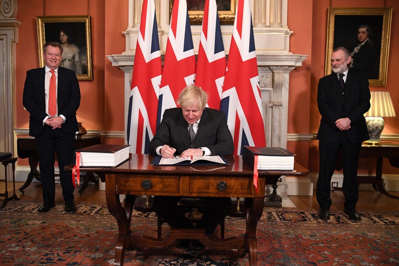 Prime Minister Boris Johnson signs the Brexit trade deal with the EU in number 10 Downing Street