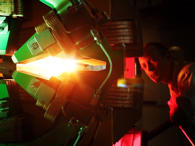 A man peers at magnet apparatus in a synchrotron.