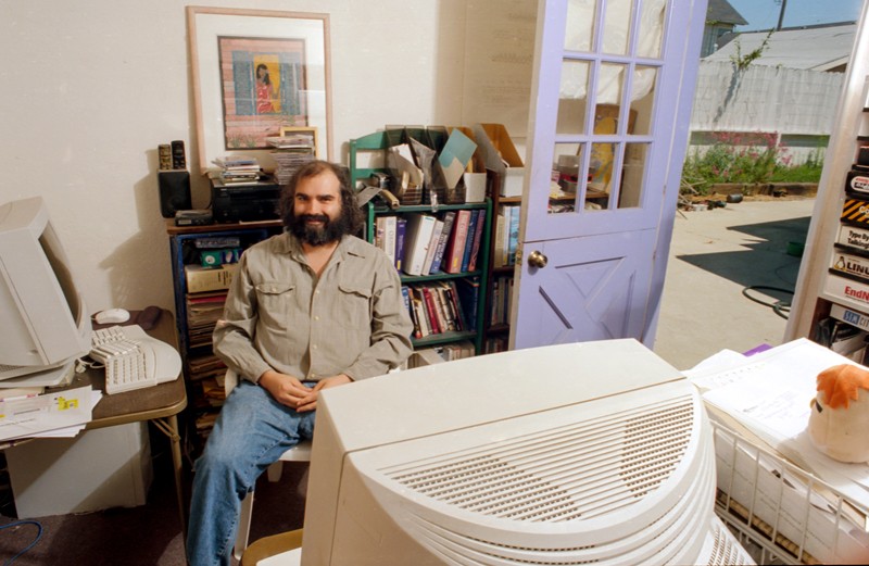 Jim Kent sitting in a garage office with two large computers in 2000