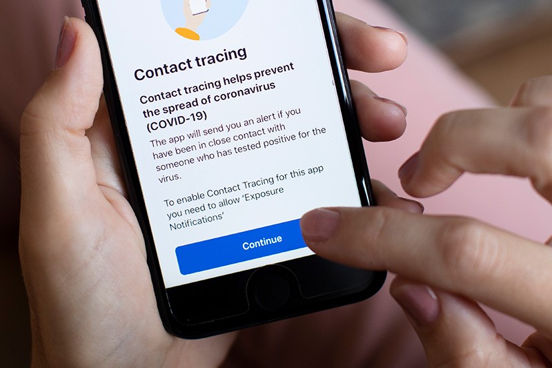 In this photo illustration, the UK governments new test and trace application is displayed on a handheld device.