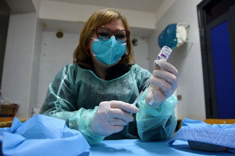 A nurse prepares syringes with the AstraZeneca vaccine